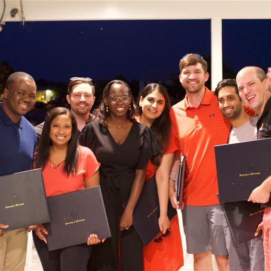 Group photo of residents with diplomas